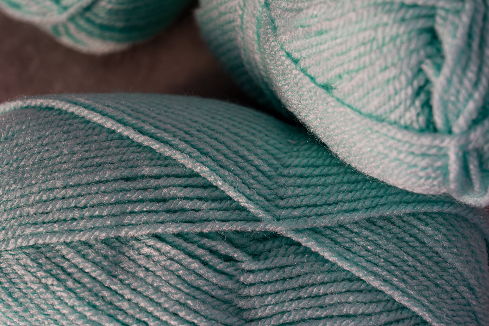 close up photo of teal yarn